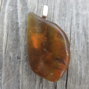 Amber pendant shaped by hand.
